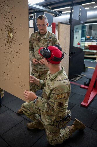 Men observe a target
