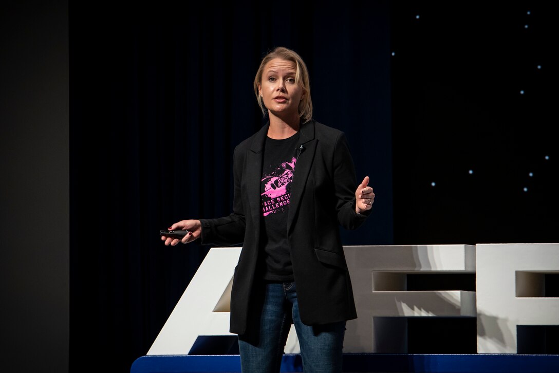 Delia Jesaitis, a communications lead action officer, presents a talk on satellite security during AFRL Inspire. The Air Force Research Laboratory hosted this special TEDx-style event at the Air Force Institute of Technology's Kenney Hall at Wright-Patterson Air Force Base, Aug. 23, 2022. (U.S. Air Force photo / Rick Eldridge)