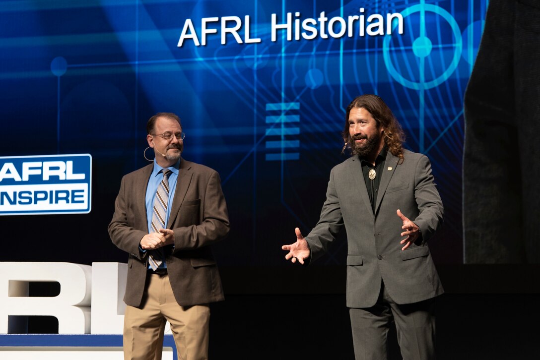 Air Force Research Laboratory historians Jeff Duford, left, and Dr. Darren Raspa, right, host AFRL Inspire in celebration of the U.S. Air Force's 75th anniversary. AFRL held this special TEDx-style event at the Air Force Institute of Technology's Kenney Hall at Wright-Patterson Air Force Base, Aug. 23, 2022. (U.S. Air Force photo / Rick Eldridge)
