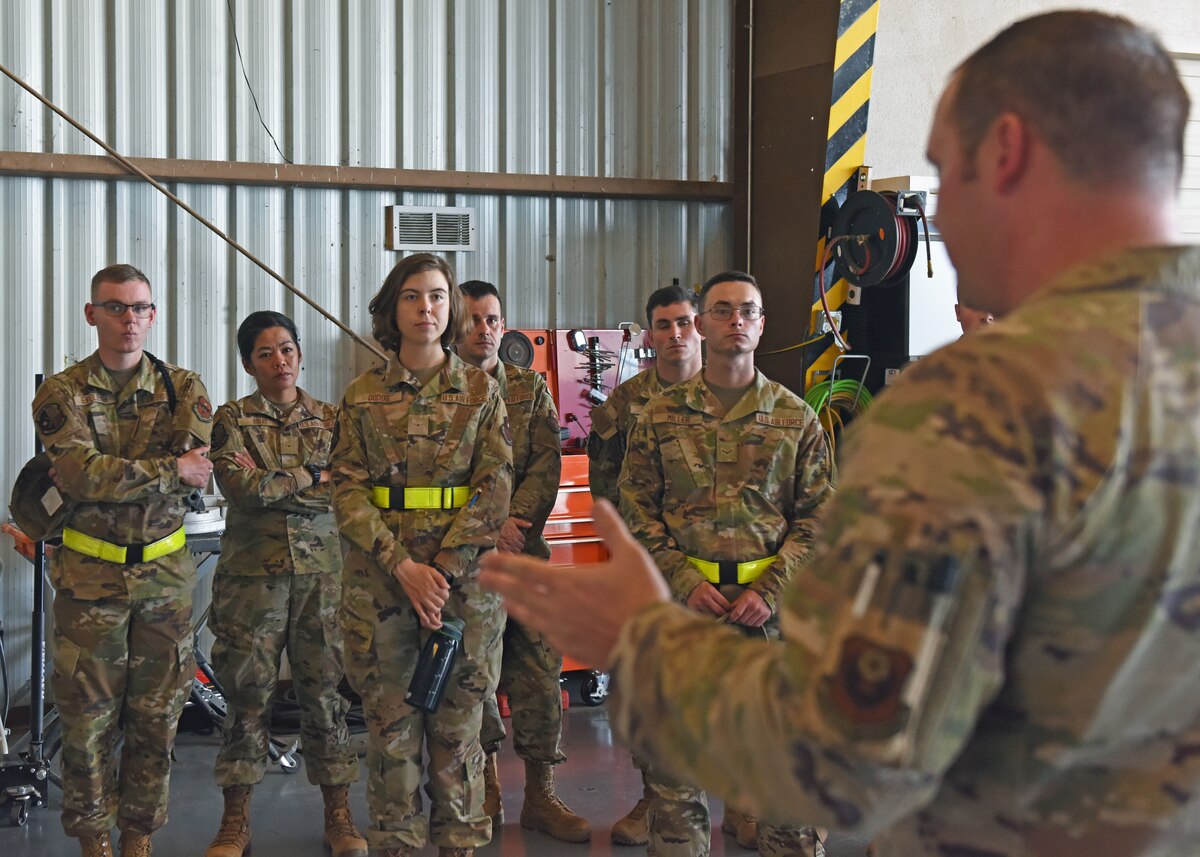 Goodfellow Air Force Base intelligence, surveillance, and reconnaissance students learn about the mission of the MC-12W from a crew member assigned to the 137th Special Operations Wing, Oklahoma National Guard, inside a hangar at San Angelo Regional Airport-Mathis Field, Texas, Aug. 24, 2022. Goodfellow AFB ISR instructors and students traveled to the airport to gain first-hand experience with this aircraft, which is assigned to 137th SOW, Oklahoma National Guard. (U.S. Air Force photo by Airman 1st Class Zachary Heimbuch)