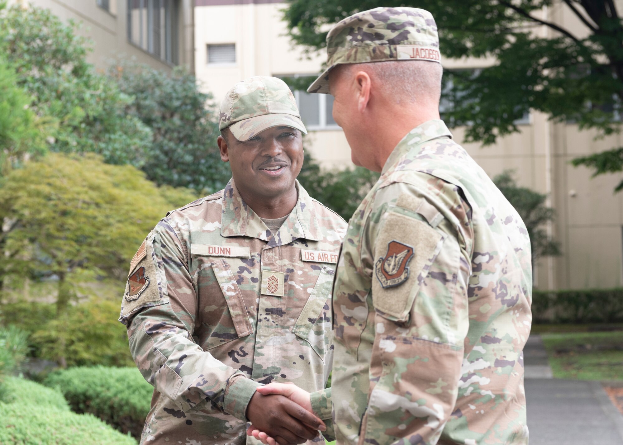 Chief Master Sgt. Jerry Dunn, 374th Airlift Wing command chief, greets Lt. Gen. James Jacobson, Pacific Air Forces deputy commander, during his visit to 374th Airlift Wing headquarters at Yokota Air Base, Japan, Aug. 22, 2022. During his visit, Jacobson met with Airmen and discussed the strategic capabilities, operations tempo and future plans for Yokota. (U.S. Air Force photo by Arita Machiko)