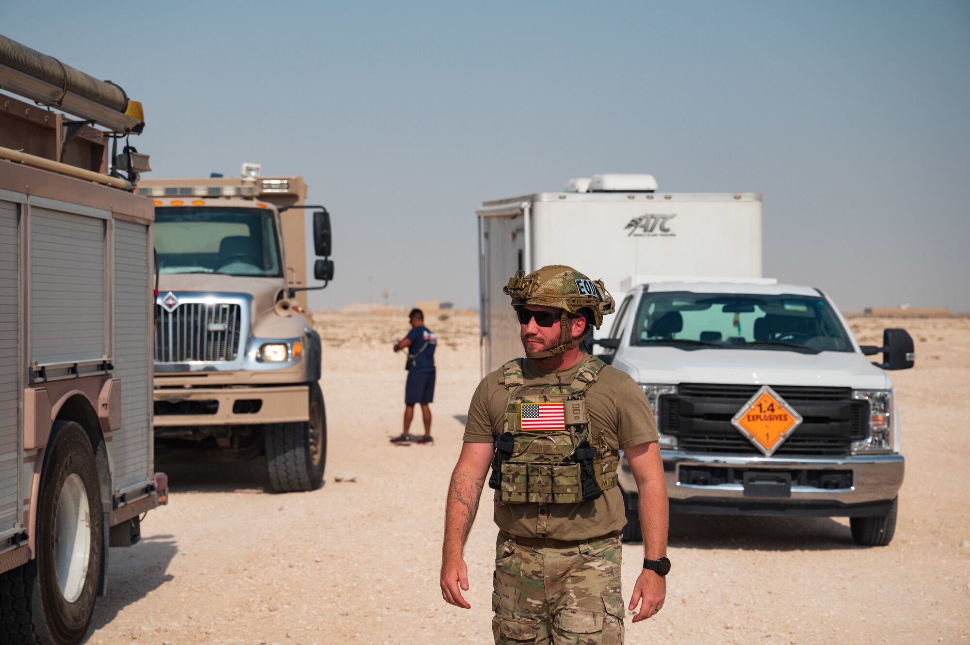 U.S. Air Force Staff Sgt. Cory Lessard, an Explosive Ordnance Disposal technician from the 379th Expeditionary Civil Engineer Squadron, arrives on scene during an exercise Aug. 24, 2022 at Al Udeid Air Base, Qatar. Lessard cleared the area of all personnel to ensure a safe distance from the explosion site during the exercise. (U.S. Air Force photo by Staff Sgt. Dana Tourtellotte)
