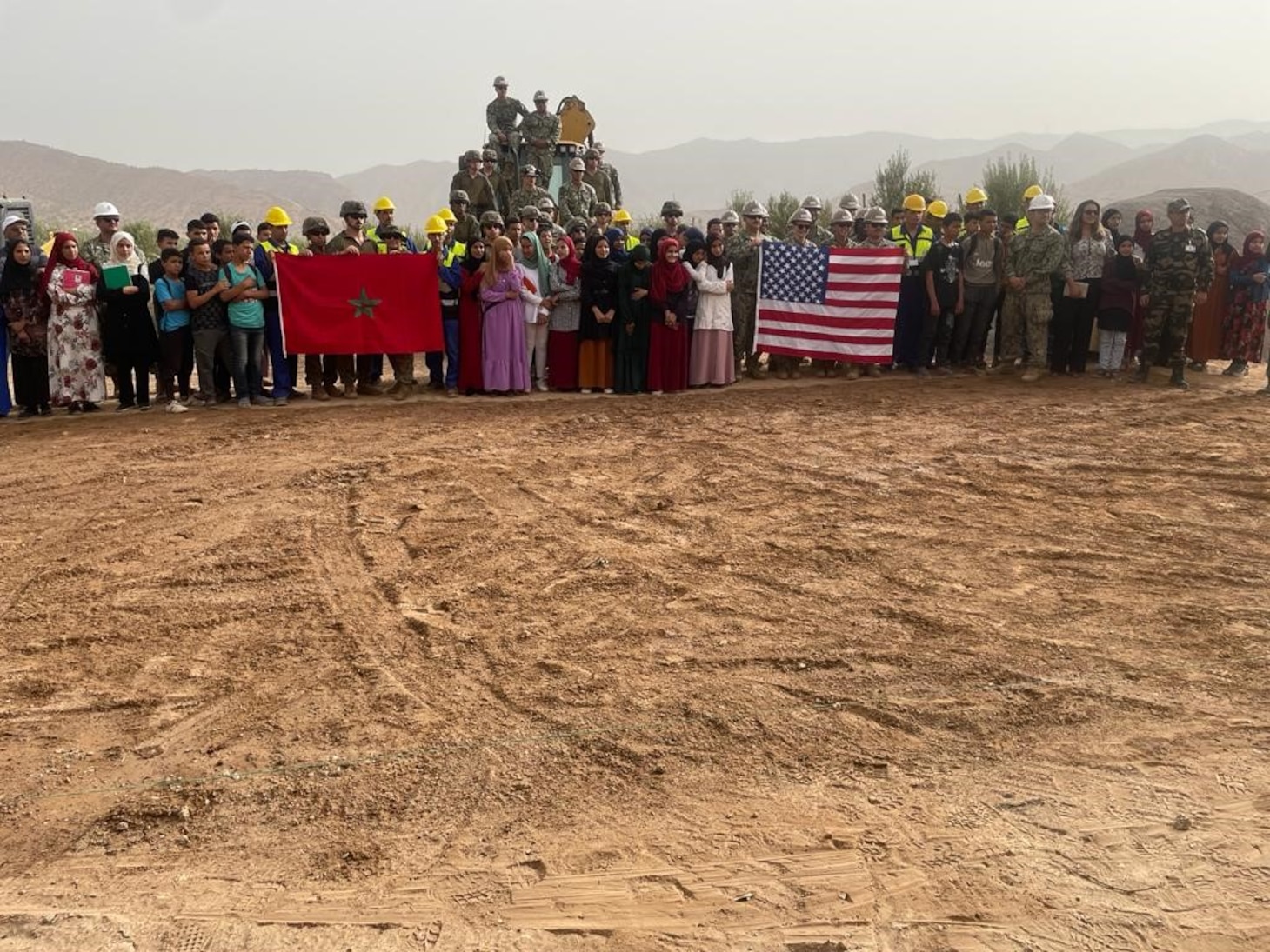U.S. Navy Seabees, assigned to Naval Mobile Construction Battalion (NMCB) 133, U.S. Marine Corps engineers from 8th Engineer Support Battalion (ESB), Royal Moroccan Army engineers, and distinguished visitors break ground on an Engineer Civic Action Project (ENCAP) during exercise African Lion 2022 (AL22) in Taliouine, Morocco, June 22, 2022.