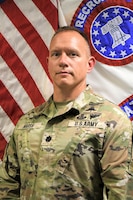 Soldier standing in front of flags