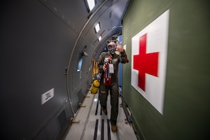 Image of an Airman giving a thumbs up on an aircraft.