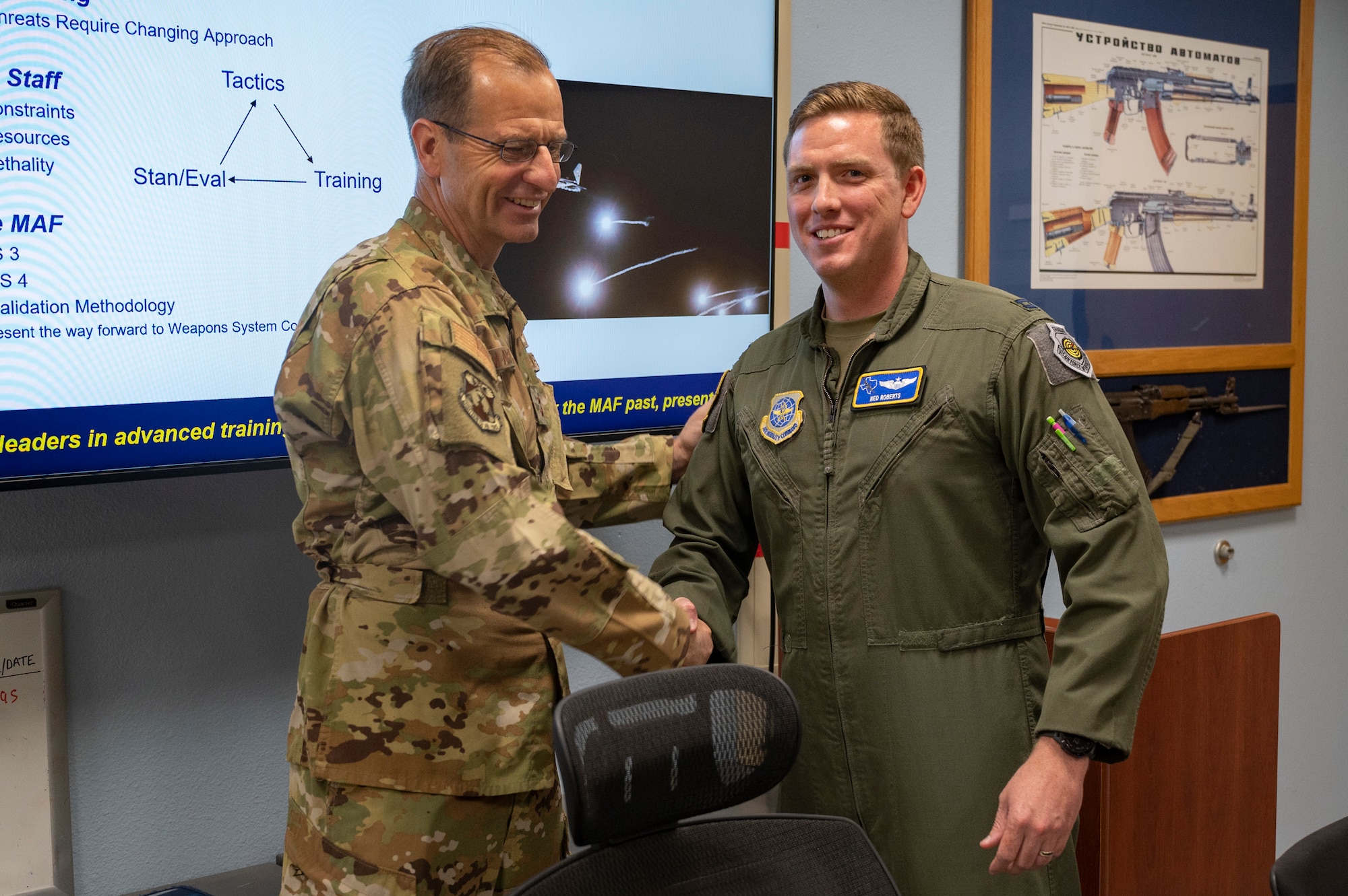 Maj. Gen. Corey Martin, 18th Air Force commander, coins Capt. Nathaniel Roberts, 40th Airlift Squadron C-130J Super Hercules pilot, at Dyess Air Force Base, Texas, Aug. 25, 2022. The 18th AF is responsible for ensuring readiness and sustainment of approximately 36,000 active duty, Reserve and civilian Airmen. (U.S. Air Force photo by Senior Airman Josiah Brown)