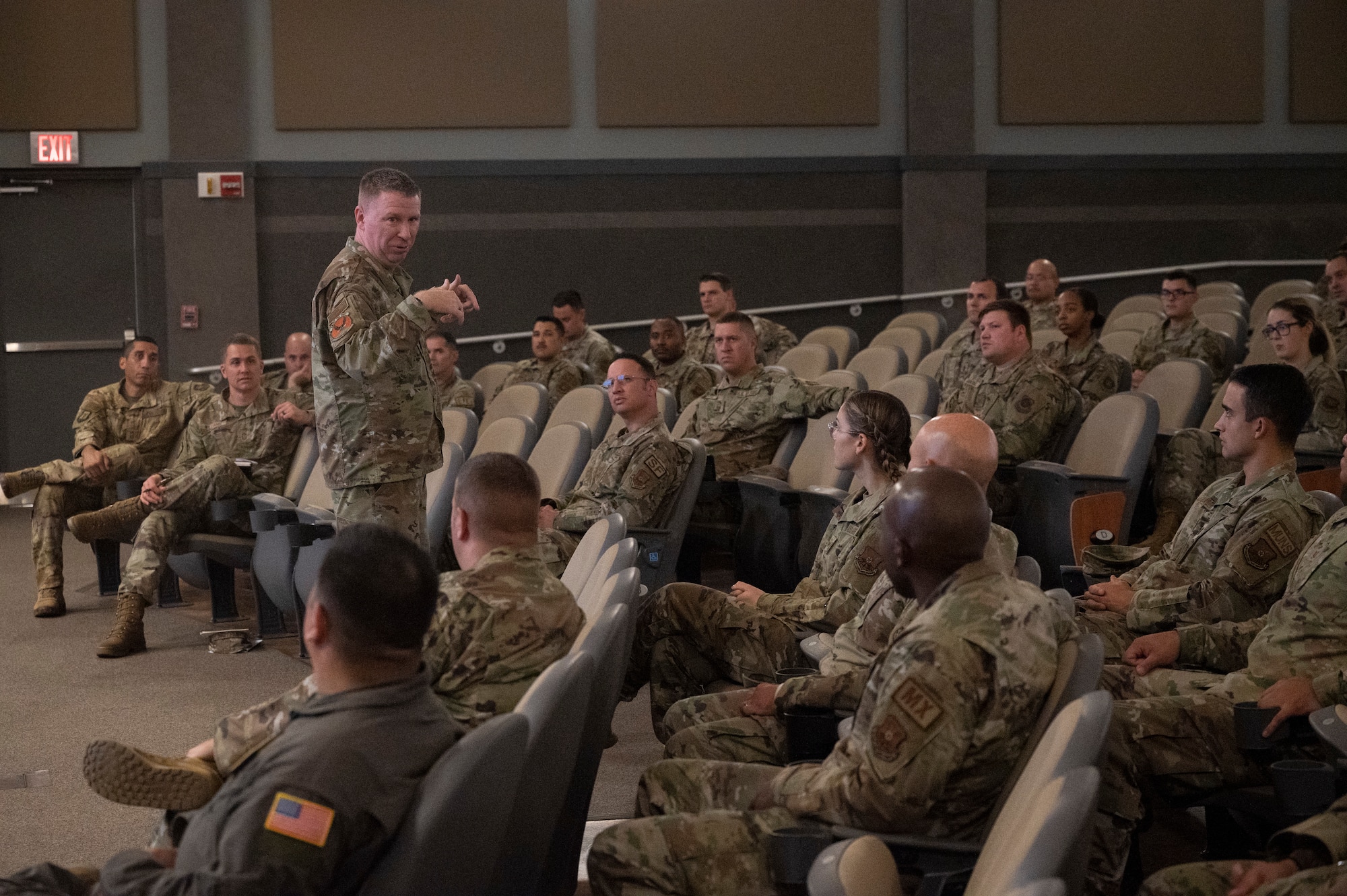 Chief Master Sgt. Chad Bickley, 18th Air Force command team, speaks to Airmen during a 317th Airlift Wing Mission Brief during his visit to Dyess Air Force Base, Texas, Aug. 25, 2022. During the Mission Brief, CMSgt. Bickley spoke on being prepared for modern era-conflict and imminent threats. (U.S. Air Force photo by Senior Airman Josiah Brown)