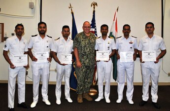(Aug. 30, 2022) SAN DIEGO -- Cmdr. Kent Davis (middle), Center for Naval Aviation Technical Training Unit North Island commanding officer, poses with the last class of Indian Navy students to graduate from MH-60R Organizational Maintenance Level courses in late July. CNATTU North Island hosted these classes for the last two years.  (U.S. Navy photo)