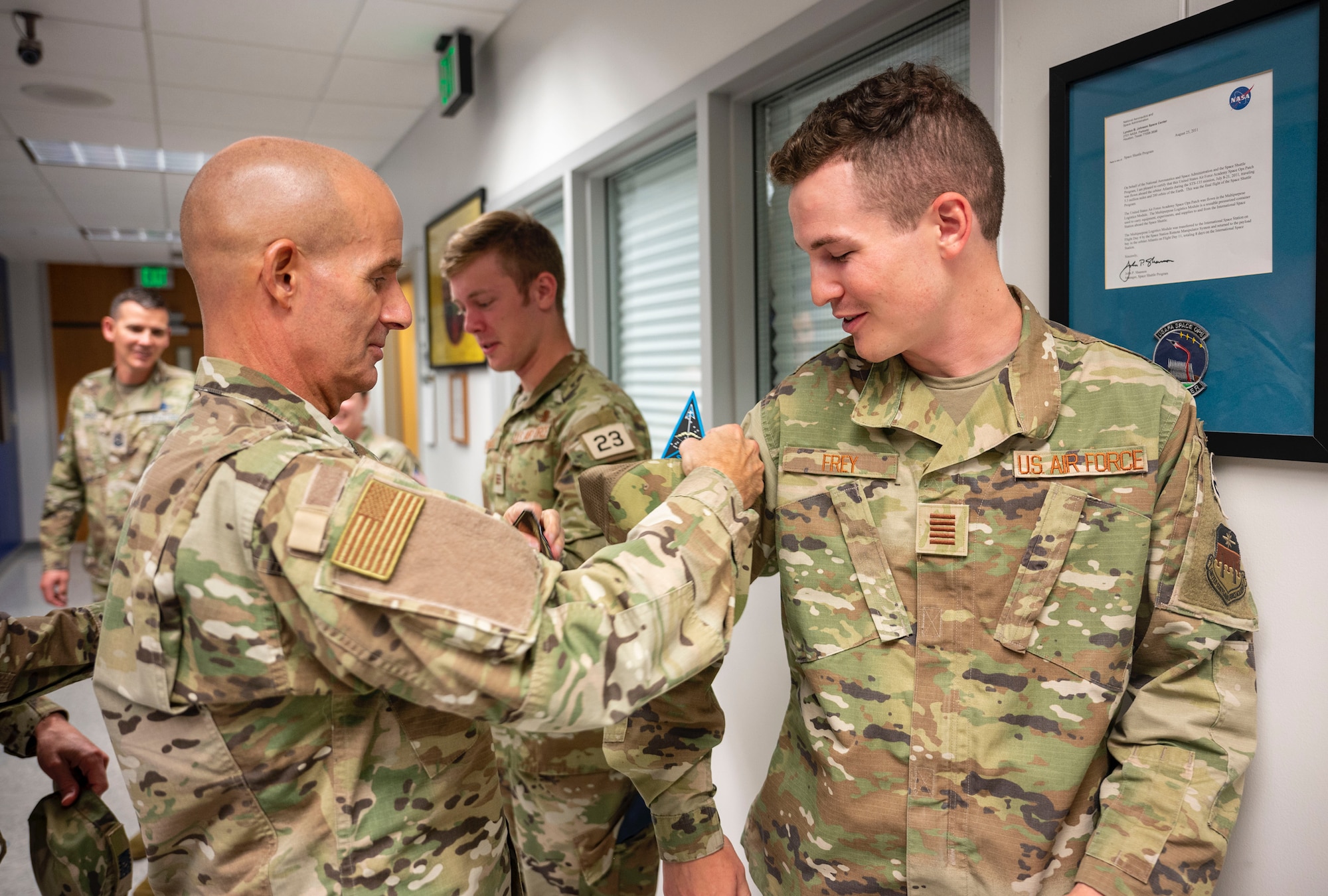 Col. Michael Assid, Space Training and Readiness Command senior IMA, gives his STARCOM patch to an U.S. Air Force Academy cadet following a tour of the FalconSAT program