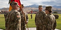 Command Sgt. Maj. Michael Sherratt secures the brigade colors during the 65th Field Artillery Brigade change-of-command ceremony at Camp Williams, Utah, Aug. 13, 2022.