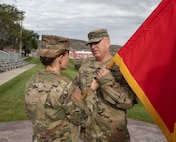 Brig. Gen. Charlene Dalto, commander-Utah National Guard Land Component Command, passes the brigade colors to Lt. Col. Jason Wilde, during the 65th Field Artillery Brigade change-of-command ceremony Aug. 13, 2022, at Camp Williams Utah.