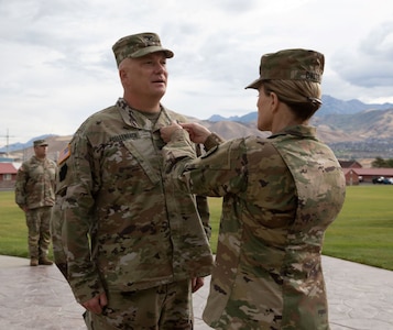 Brig. Gen. Charlene Dalto, commander, Utah National Guard Land Component Command, presents the Legion of Merit to Col. Shawn Fuellenbach for his exceptional leadership as the 65th Field Artillery Brigade commander during the brigade change-of-command on Aug. 13, 2022.