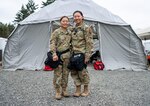 U.S. Army Spc. Jessica Lee, left, 928th Area Support Medical Company, Colorado Army National Guard, and U.S. Air Force Senior Airman Julie Lee, 140th Medical Group, Colorado Air National Guard ,participate in an external evaluation at Camp Rilea, Oregon, July 12, 2022. The sisters serve together in the Colorado National Guard’s Chemical, Biological, Radiological, Nuclear and high-yield explosive Enhanced Response Force Package.