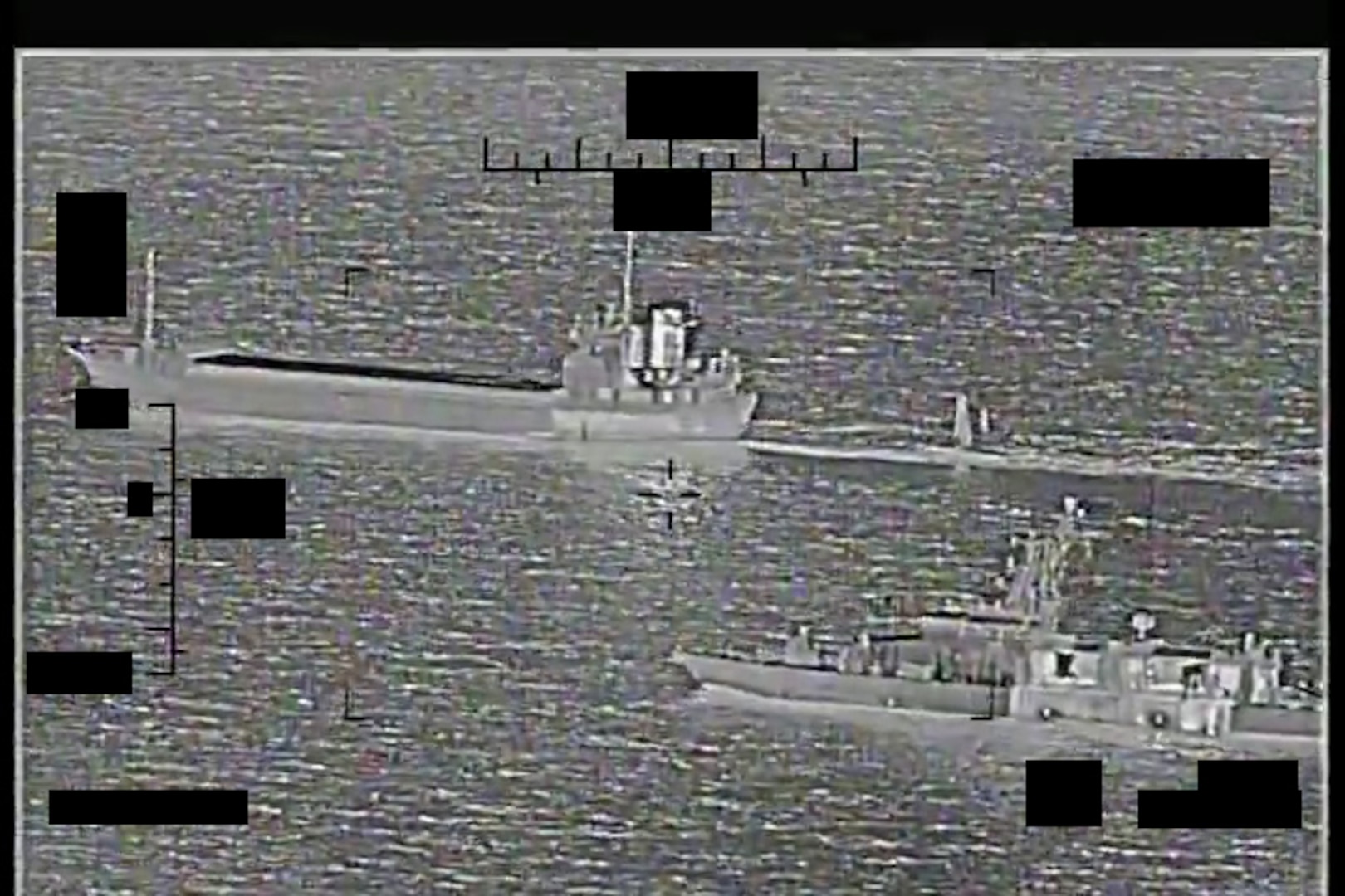 ARABIAN GULF (Aug. 30, 2022) Screenshot of a video showing support ship Shahid Baziar, left, from Iran's Islamic Revolutionary Guard Corps Navy unlawfully towing a Saildrone Explorer unmanned surface vessel in international waters of the Arabian Gulf as U.S. Navy patrol coastal ship USS Thunderbolt (PC 12) approaches in response, Aug. 30.