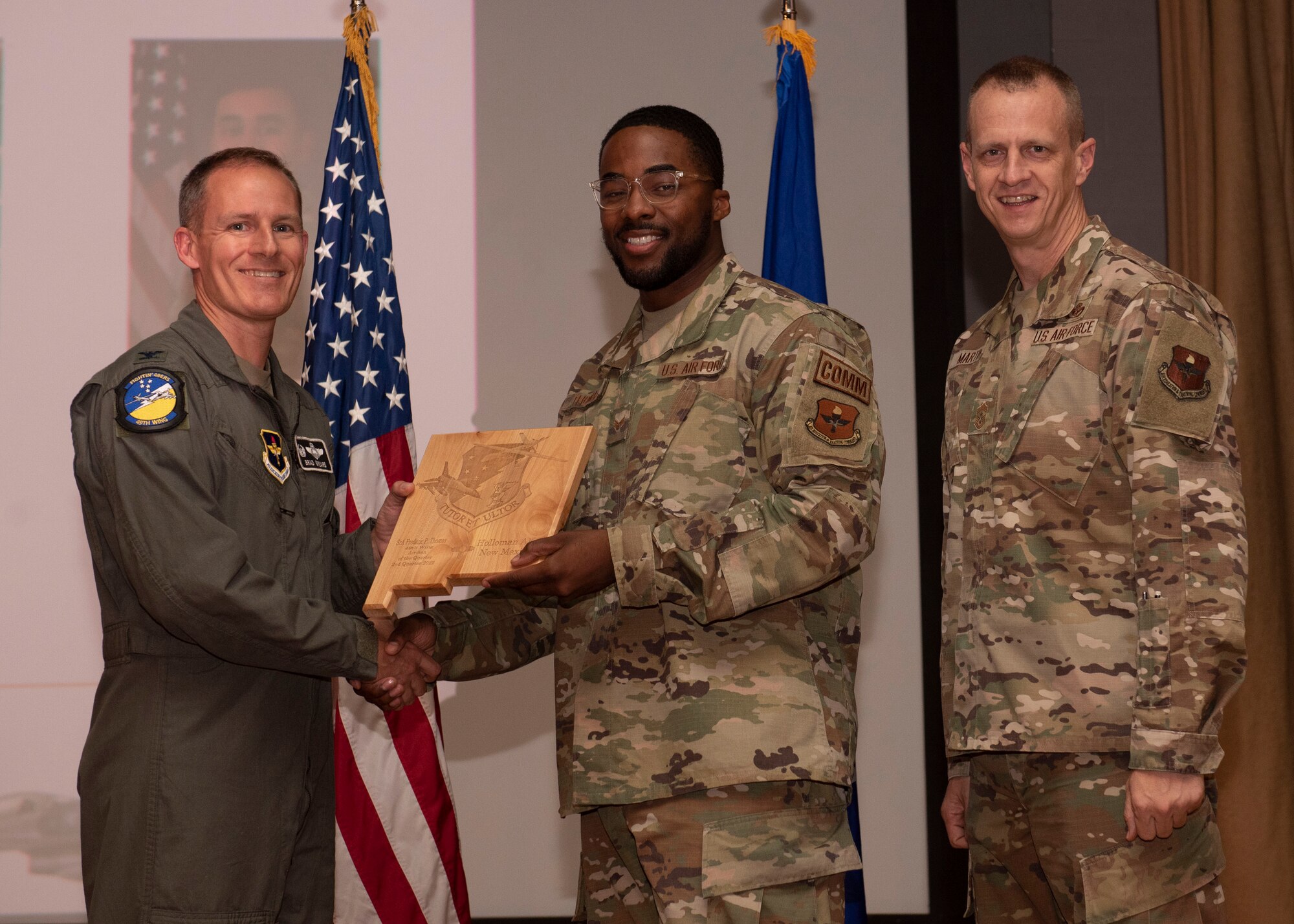U.S. Air Force Senior Airman Frederic Thomas, from the 49th Communications Squadron, accepts the Airman of the Quarter award during the 49th Wing’s 2nd quarter award ceremony, Aug. 29, 2022, at Holloman Air Force Base, New Mexico. Quarterly award winners were selected based on their technical expertise, demonstration of leadership and job performance. (U.S. Air Force photo by Airman 1st Class Nicholas Paczkowski)