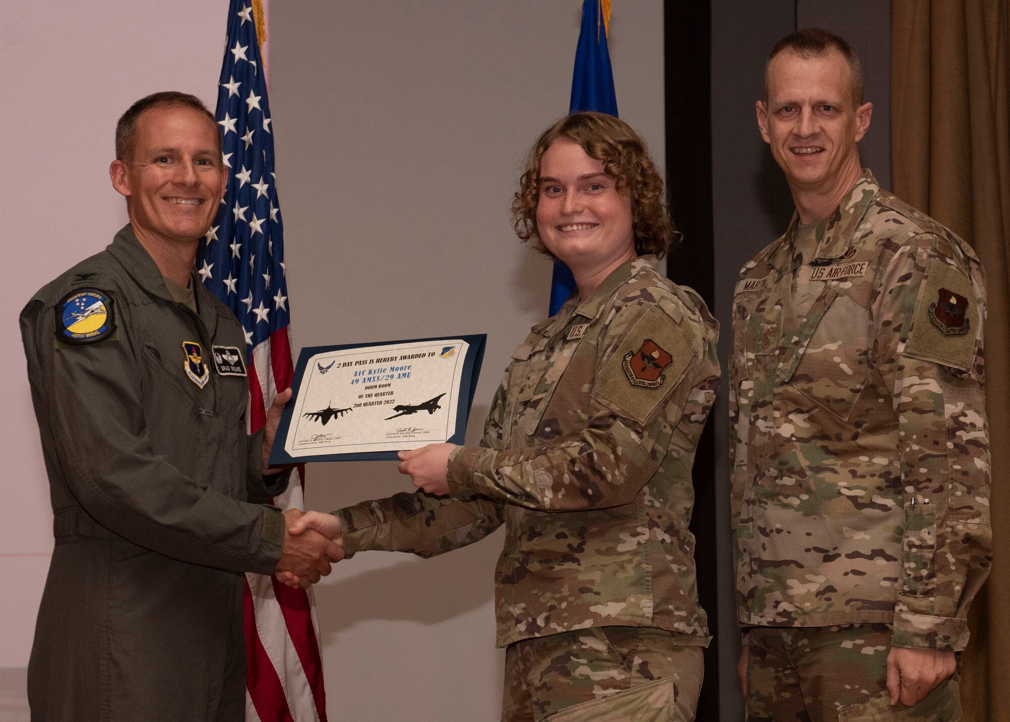 U.S. Air Force Airman 1st Class Kylie Moore, from the Aircraft Maintenance Squadron, accepts the dorm room of the quarter award during the 49th Wing’s 2nd quarter award ceremony, Aug. 29, 2022, at Holloman Air Force Base, New Mexico. Quarterly award winners were selected based on their technical expertise, demonstration of leadership and job performance. (U.S. Air Force photo by Airman 1st Class Nicholas Paczkowski)