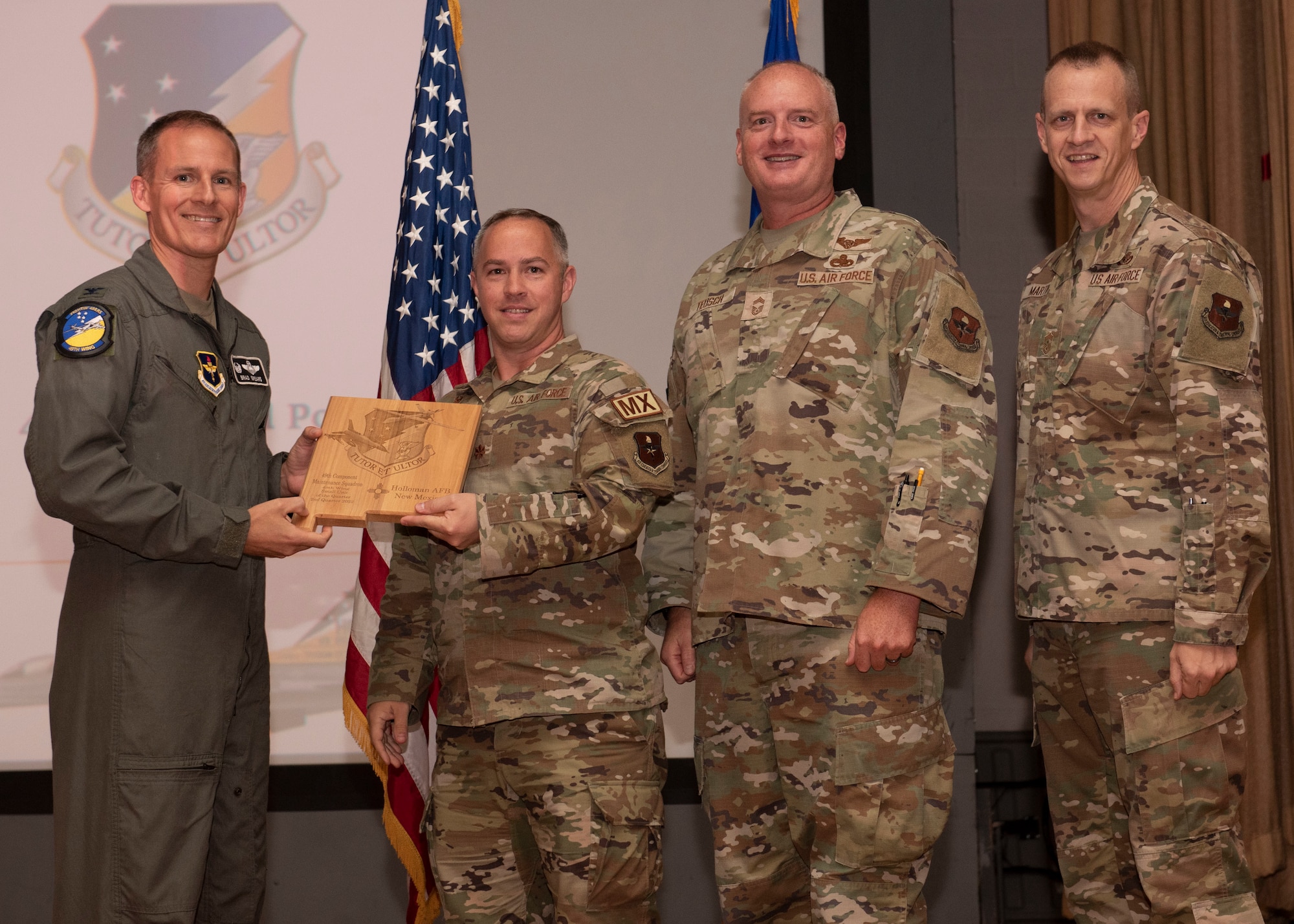 Representatives from the 49th Component Maintenance Squadron accept the small unit of the quarter award during the 49th Wing’s 2nd quarter award ceremony, Aug. 29, 2022, at Holloman Air Force Base, New Mexico. Quarterly award winners were selected based on their technical expertise, demonstration of leadership and job performance. (U.S. Air Force photo by Airman 1st Class Nicholas Paczkowski)