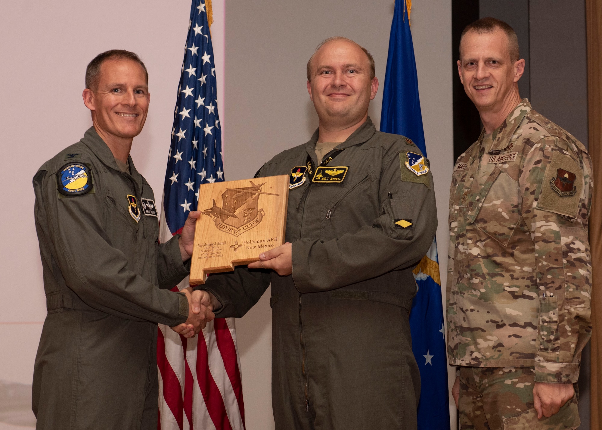 U.S. Air Force Maj. Matthew Jerrell, from the 314th Fighter Squadron, accepts the Instructor Pilot of the Quarter award during the 49th Wing’s 2nd quarter award ceremony, Aug. 29, 2022, at Holloman Air Force Base, New Mexico. Quarterly award winners were selected based on their technical expertise, demonstration of leadership and job performance. (U.S. Air Force photo by Airman 1st Class Nicholas Paczkowski)