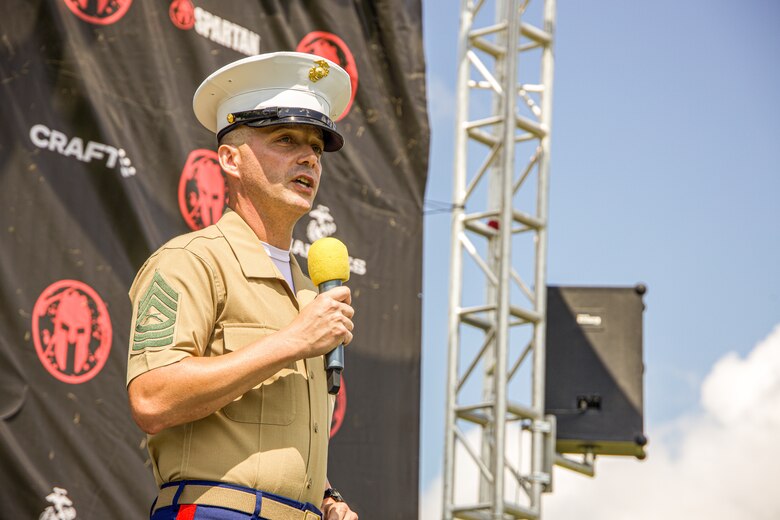 U.S. Marine Corps Master Sgt. Jeremy C. Bowen, trial services chief, Legal Services Support Section Quantico, Virginia, delivers his remarks during tat the Sprint 5K at the 2022 West Virginia Spartan Trifecta Weekend Event in Glen Jean, West Virginia, Aug. 28, 2022.  Marine Corps Recruiting Command has partnered with the Spartan Race and their community of Athletes during 2022 through National and local level event activations. The partnership celebrates athletes' discipline, fighting spirit, and will to overcome obstacles and complete the mission are values shared with the Corps. (U.S. Marine Corps photo by Lance Cpl. Gustavo Romero)
