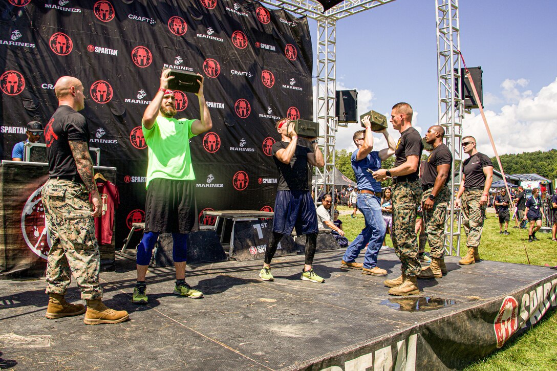 U.S. Marines aboard Marine Corps Base Quantico, manage the Marine Corps festival challenge during the Sprint 5K at the 2022 West Virginia Spartan Trifecta Weekend Event in Glen Jean, West Virginia, Aug. 28, 2022.  Marine Corps Recruiting Command has partnered with the Spartan Race and their community of Athletes during 2022 through National and local level event activations. The partnership celebrates athletes' discipline, fighting spirit, and will to overcome obstacles and complete the mission are values shared with the Corps. (U.S. Marine Corps photo by Lance Cpl. Gustavo Romero)