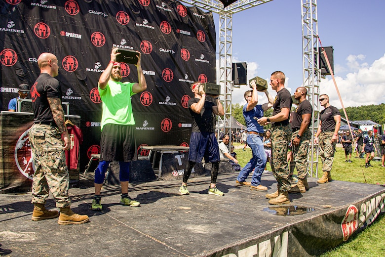 U.S. Marines aboard Marine Corps Base Quantico, manage the Marine Corps festival challenge during the Sprint 5K at the 2022 West Virginia Spartan Trifecta Weekend Event in Glen Jean, West Virginia, Aug. 28, 2022.  Marine Corps Recruiting Command has partnered with the Spartan Race and their community of Athletes during 2022 through National and local level event activations. The partnership celebrates athletes' discipline, fighting spirit, and will to overcome obstacles and complete the mission are values shared with the Corps. (U.S. Marine Corps photo by Lance Cpl. Gustavo Romero)