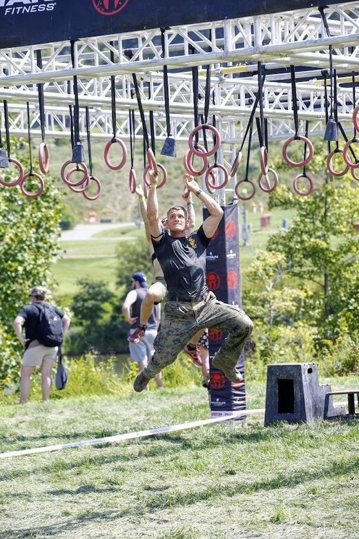 U.S. Marine Corps Staff Sgt. Joseph Stich, Force Fitness Instructor Trainer with the Martial Arts and Fitness Center of Excellence in Quantico, Virginia moves across from the "Multi-Rig" during the running of the Sprint 5K at the 2022 West Virginia Spartan Trifecta Weekend Event in Glen Jean, West Virginia, Aug. 28, 2022.  Marine Corps Recruiting Command has partnered with the Spartan Race and their community of Athletes during 2022 through National and local level event activations.