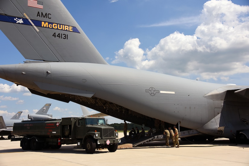 Airmen use fuel truck to commence defuel operations from the C-17.