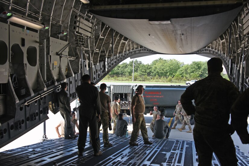 Airmen from 6th Airlift Squadron and 87th Logistics Readiness Squadron perform defuel operations from the C-17.