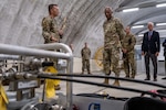 U.S. Air Force Master Sgt. Jason Yunker, left, 18th Logistics Readiness Squadron fuels quality and compliance section chief, explains his spark tank invention to U.S. Air Force Chief of Staff Gen. CQ Brown, Jr., right, during his visit to Kadena Air Base, Japan, Aug. 11, 2022. Yunker’s project, which won first place in the Pacific Air Forces Spark Tank 2022, repurposed pieces of unused equipment to create an additive injector which converts commercial fuel into military-grade fuel acceptable for aircraft.