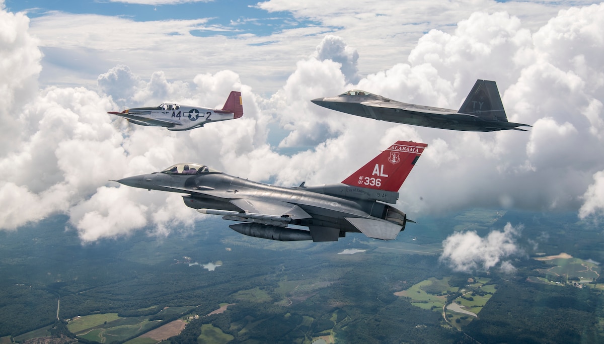 A U.S. Air Force F-22 Raptor, F-16 Fighting Falcon and a Commemorative Air Force P-51 Mustang fly in formation Sep. 6, 2018, while flying over areas of Alabama.