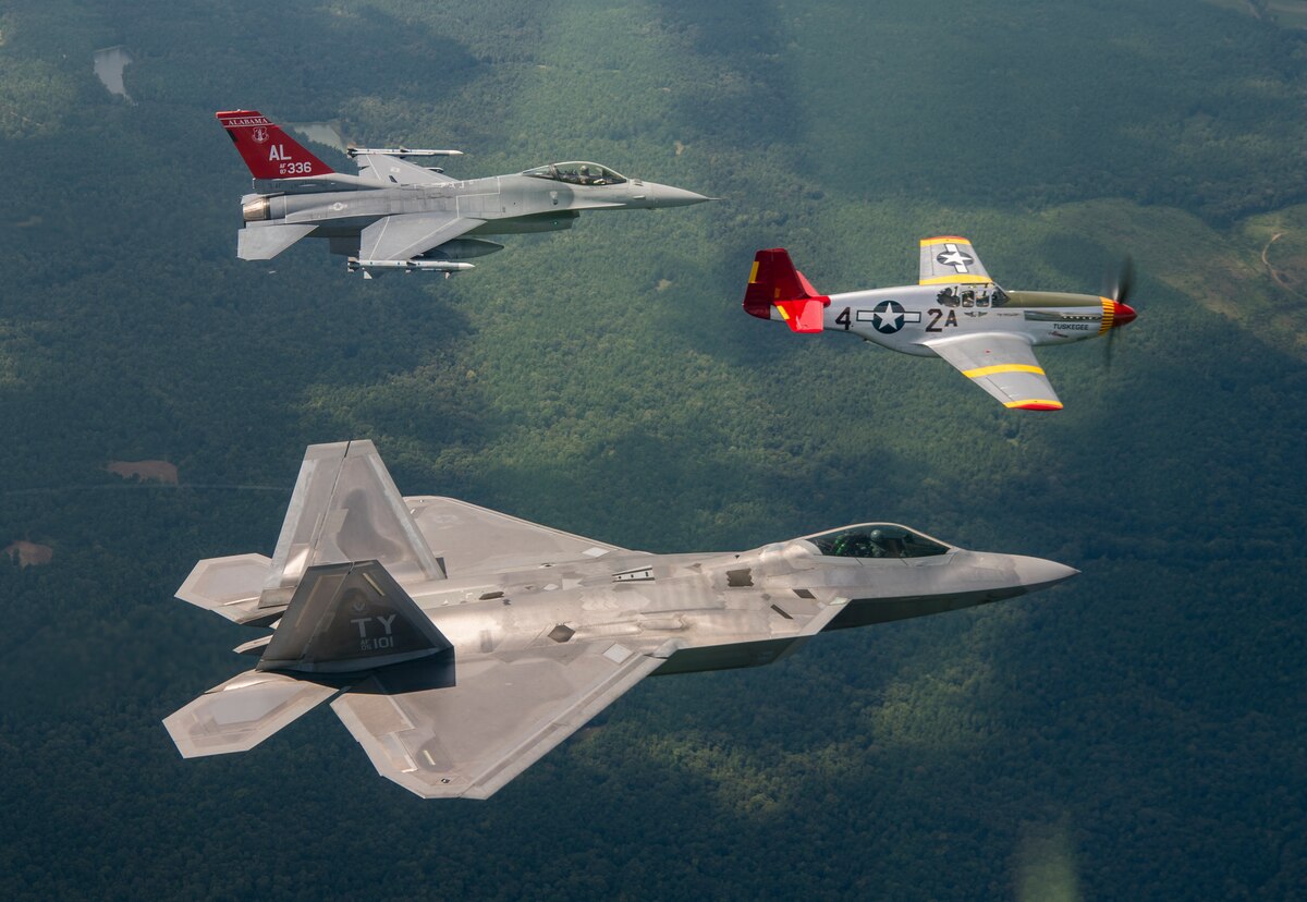 A U.S. Air Force F-22 Raptor, F-16 Fighting Falcon and a Commemorative Air Force P-51 Mustang fly in formation Sep. 6, 2018, while flying over areas of Alabama.