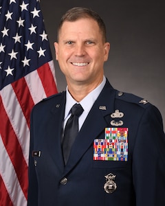 Man in uniform smiles at camera