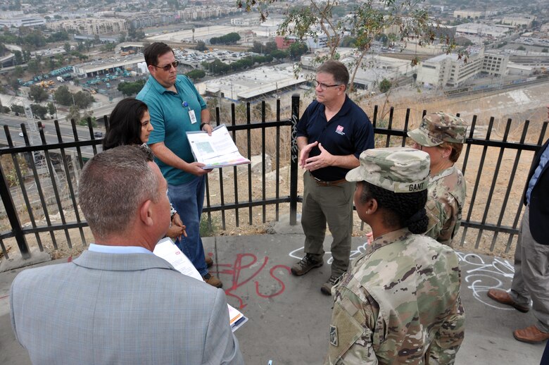 High above the Los Angeles River, project manager Priyanka Wadhawan and senior geological engineer Chris Spitzer, U.S. Army Corps of Engineers Los Angeles District, left, brief Al Lee, director of Civil Works, Senior Executive Service, U.S. Army Corps of Engineers Headquarters, about the LA River Ecosystem Restoration project Aug. 22 at Elysium Park in Los Angeles.