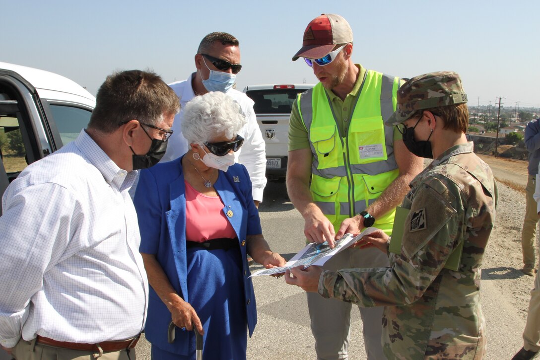 Col. Julie Balten, LA District commander, right, and Aaron Smith, senior dam safety adviser, second from right, discuss the Whittier Narrows Dam Safety Modification Project with 32nd Congressional District Rep. Grace Napolitano during a tour of the dam Aug. 23 in Montebello, California. At left is Al Lee, director of civil works for the U.S. Army Corps of Engineers. Behind Napolitano is Justin Gay, LA District’s deputy district engineer.