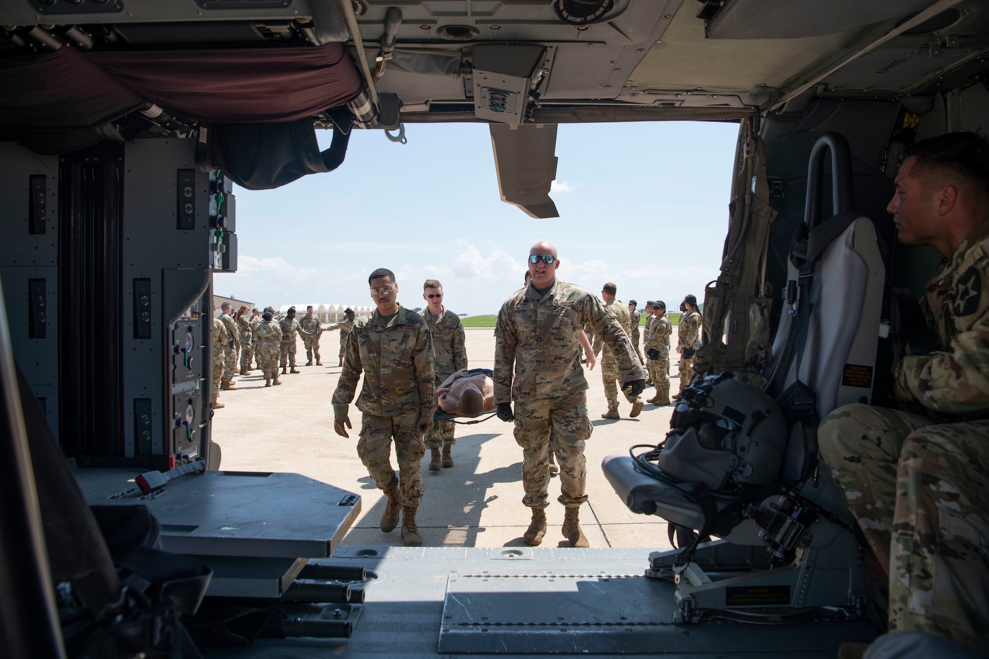 Airmen with the 8th Medical Group perform a litter carry during a training event at Kunsan Air Base, Republic of Korea, Aug. 18, 2022. The 8th MDG is devoted to optimizing the installation’s readiness in preparation of follow-on forces. (U.S. Air Force photo by Staff Sgt. Sadie Colbert)