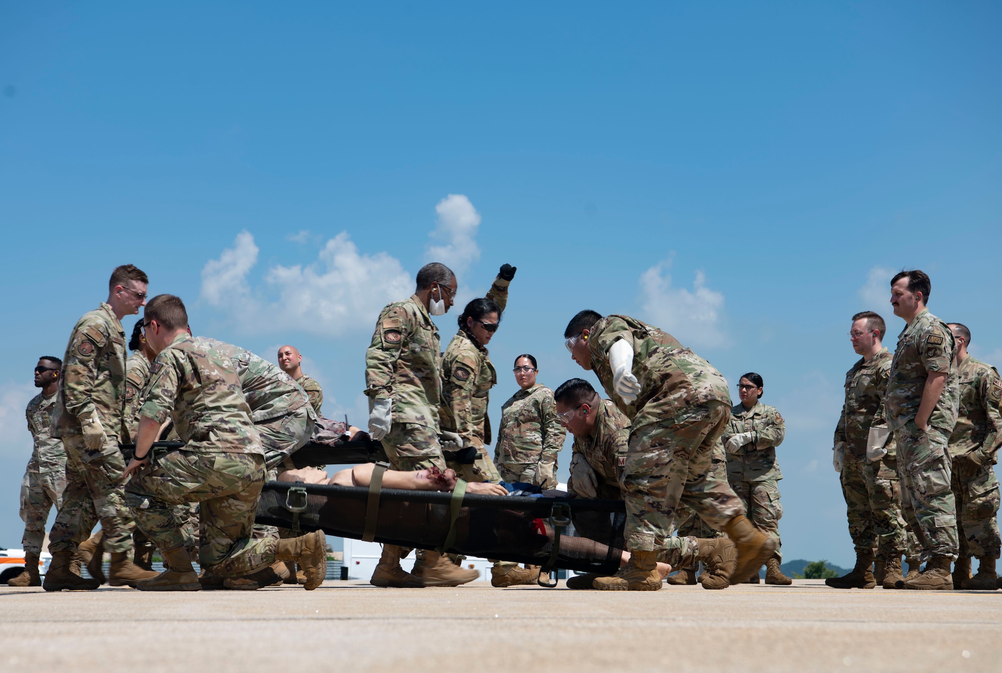 Airmen with the 8th Medical Group perform a litter carry during a training event at Kunsan Air Base, Republic of Korea, Aug. 18, 2022. The 8th MDG is devoted to optimizing the installation’s readiness in preparation of follow-on forces. (U.S. Air Force photo by Staff Sgt. Sadie Colbert)