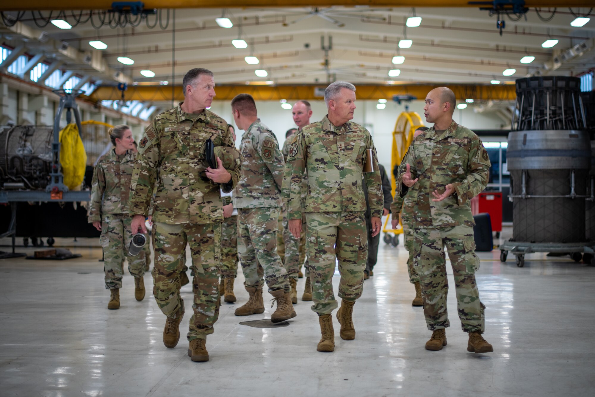 Airmen walk through a facility.