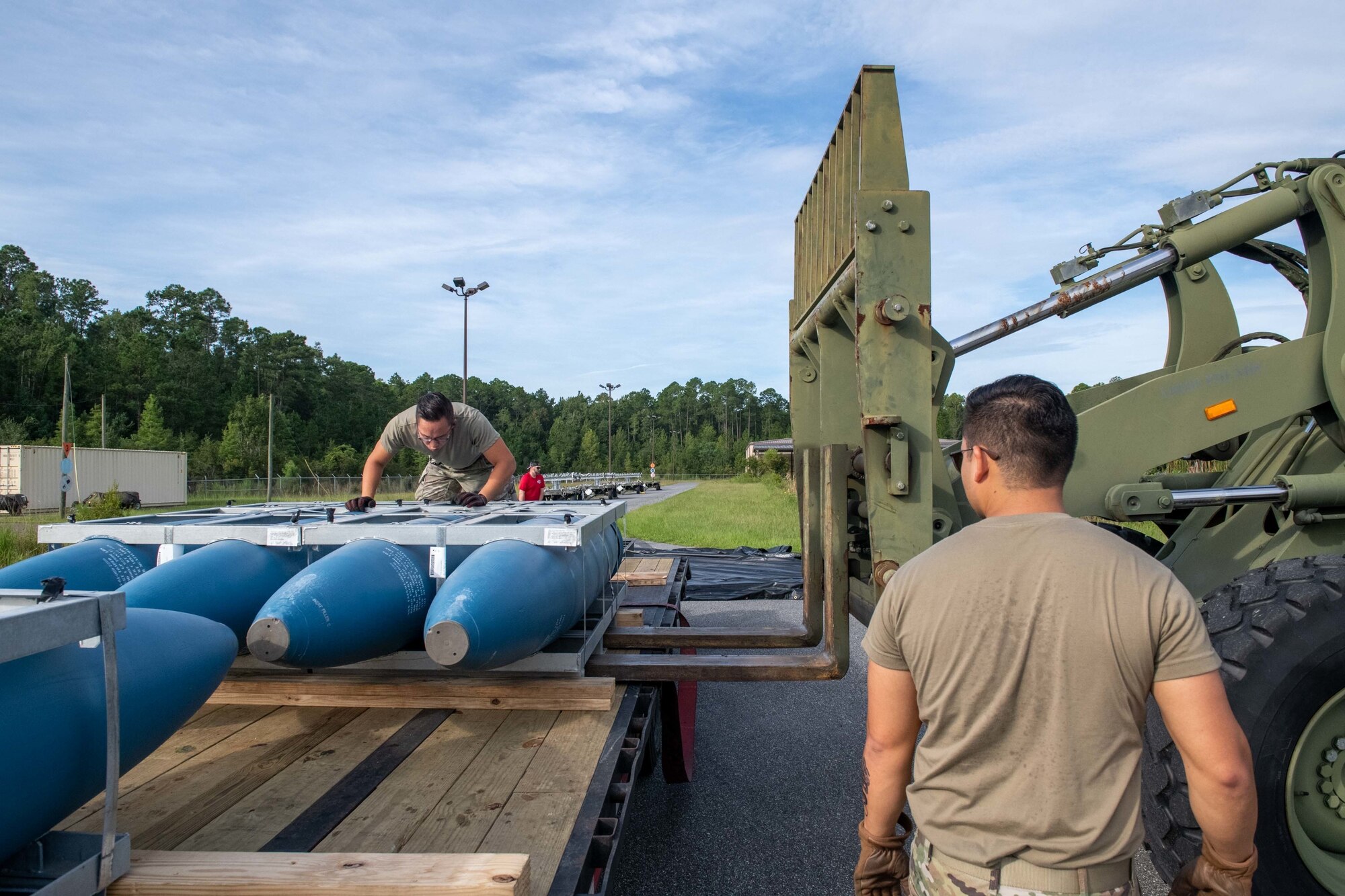 U.S. Air Force Staff Sgt. Huy Dinh, 125th Munitions Flight line delivery production supervisor, unloads training munitions that arrived at the 125th Fighter Wing, Florida Air National Guard, on Aug. 24, 2022. The inert general purpose bombs, called the MK-84s, are the first air-to-ground training assets to arrive for the new F-35 Lightning II mission. (U.S. Air National Guard photo by Tech Sgt. Chelsea Smith)