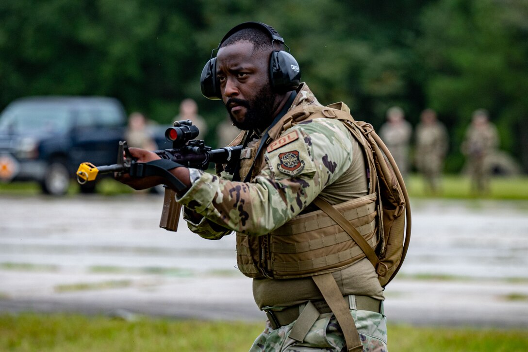 A photo of an Airman with a weapon.