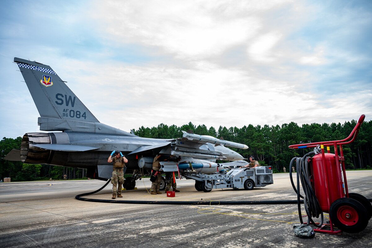 A photo of Airman and an F-16 Fighting Falcon.