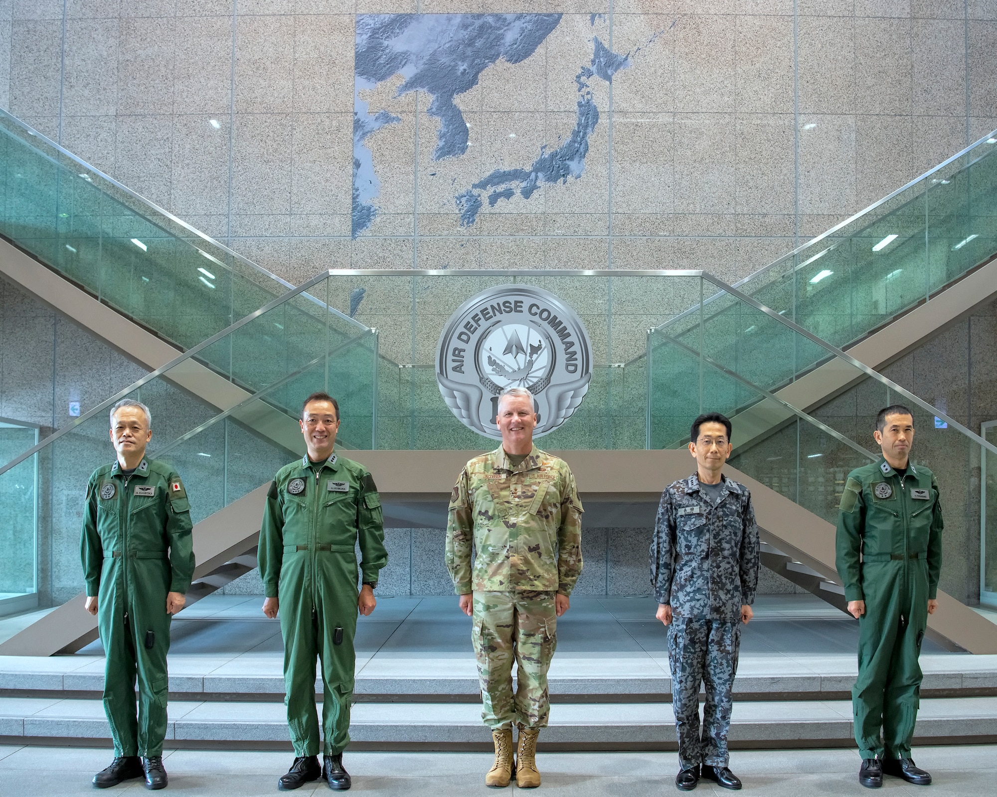 U.S. Air Force Lt. Gen. James Jacobson, Pacific Air Forces deputy commander, center, and Japan Air Self-Defense Force Lt. Gen. Hiroaki Uchikura, Air Defense Command commander, second left, pose for a photo with JASDF senior leaders in the JASDF ADC headquarters at Yokota Air Base, Japan, Aug. 22, 2022. Jacobson toured the ADC headquarters where approximately 800 JASDF personnel work at Yokota. (U.S. Air Force photo by Yasuo Osakabe)