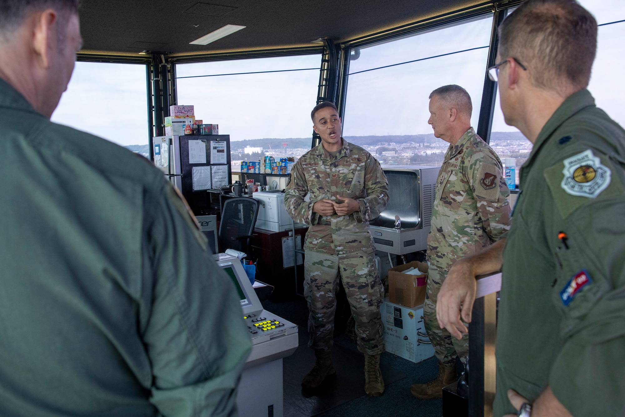 Tech. Sgt. James Freeman, 374th Operations Support Squadron chief controller, gives a brief to Lt. Gen. James Jacobson, Pacific Air Forces deputy commander, at Yokota Air Base, Japan, Aug. 22, 2022. During the visit, Jacobson toured various facilities to see current projects and developmental plans for Yokota. (U.S. Air Force photo by Yasuo Osakabe)