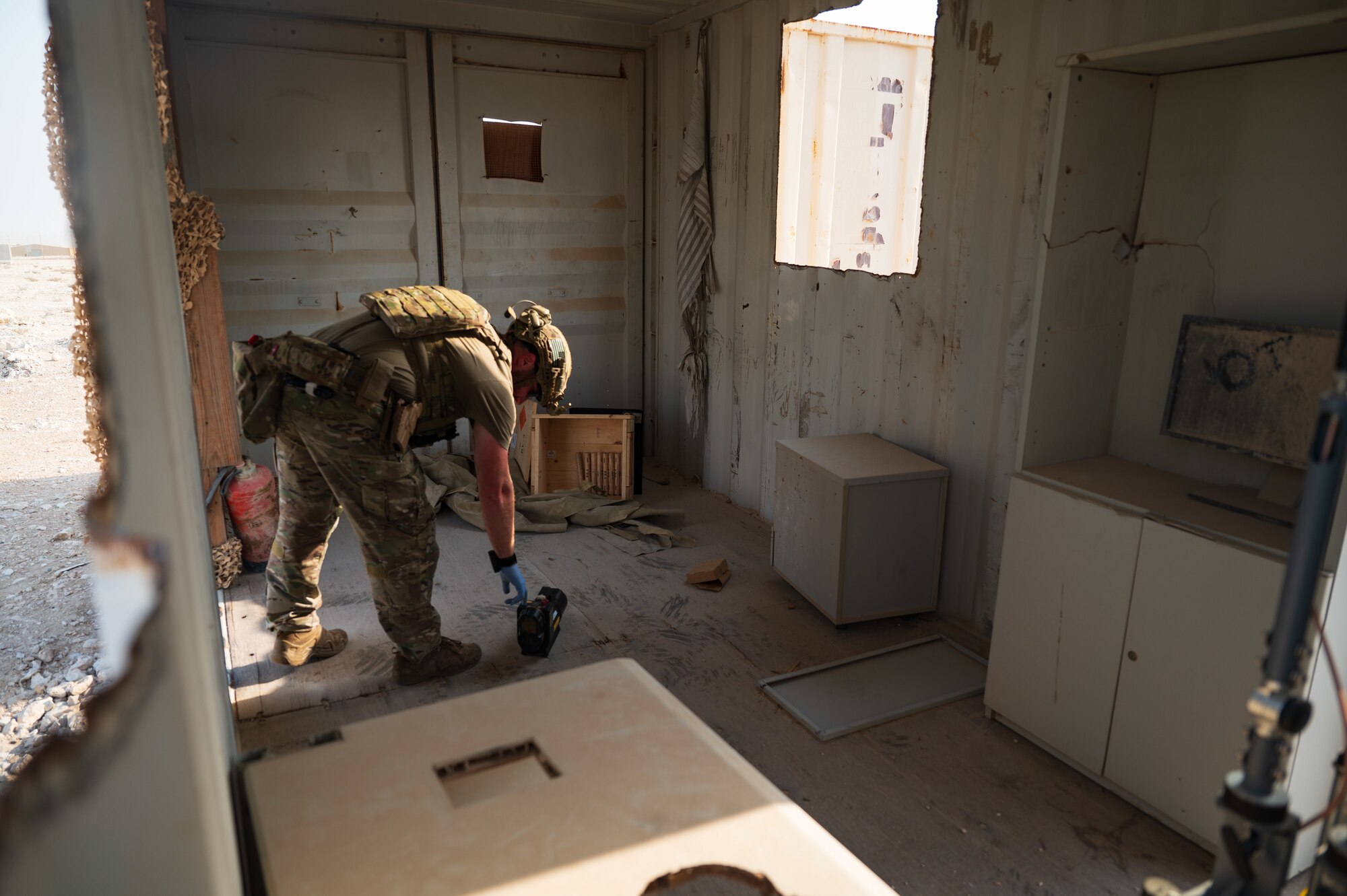 U.S. Air Force Staff Sgt. Cory Lessard, an Explosive Ordnance Disposal technician from the 379th Expeditionary Civil Engineer Squadron, sets up and activates an X-Ray to further evaluate the threat of found explosives during an exercise Aug. 24, 2022 at Al Udeid Air Base, Qatar. The X-Ray set up was simple and required only a moment and two small pieces of equipment to put into place. (U.S. Air Force photo by Staff Sgt. Dana Tourtellotte)