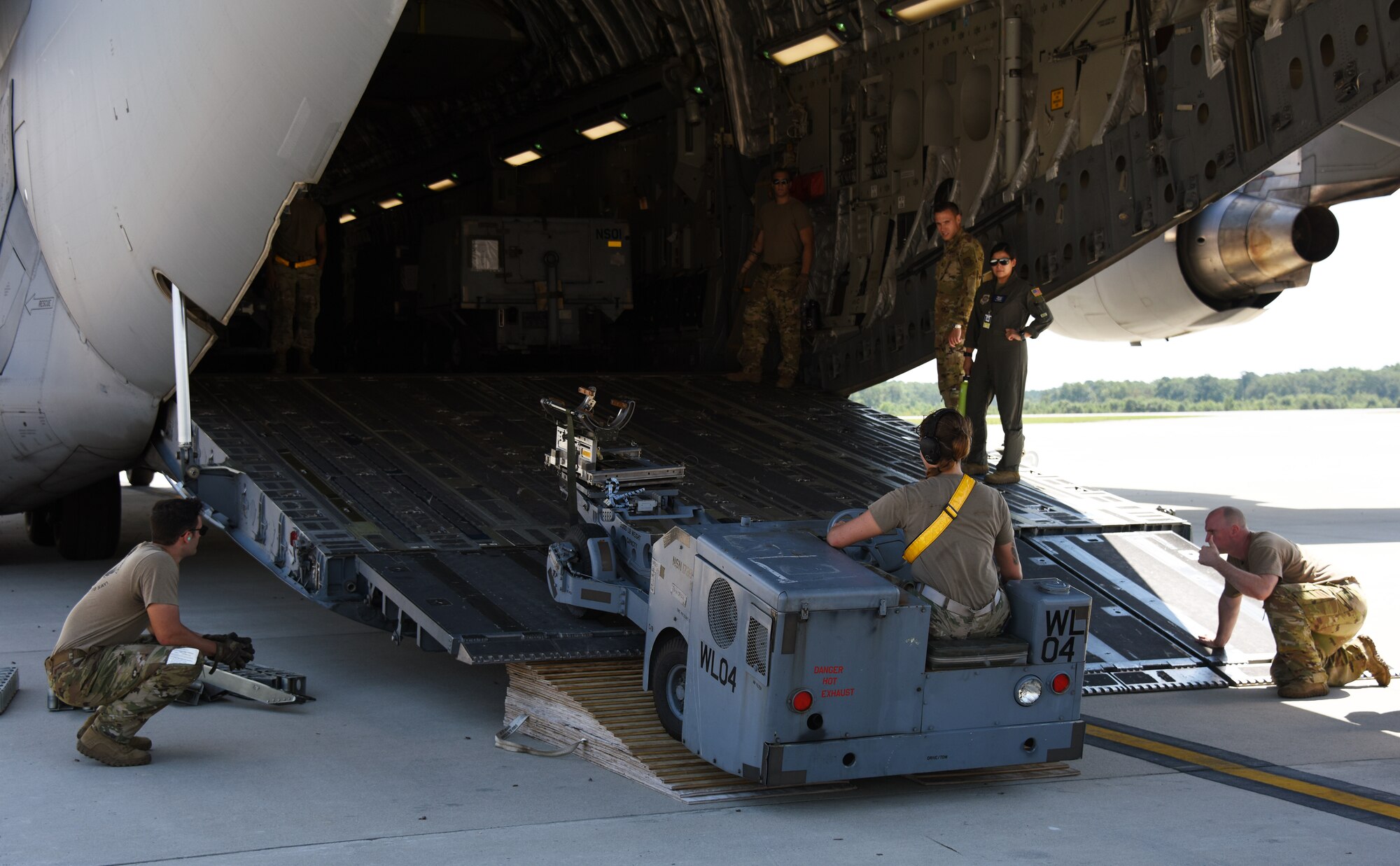 Airmen upload a jammer back into the C-17 during Agile Combat Employment training.