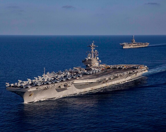 The Nimitz-class aircraft carrier USS George H.W. Bush (CVN 77), bottom, operates with the Nimitz-class aircraft carrier USS Harry S. Truman (CVN 75), Aug. 27, 2022.