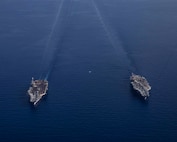 The Nimitz-class aircraft carrier USS George H.W. Bush (CVN 77), bottom, operates with the Nimitz-class aircraft carrier USS Harry S. Truman (CVN 75), Aug. 27, 2022.