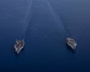 The Nimitz-class aircraft carrier USS George H.W. Bush (CVN 77), bottom, operates with the Nimitz-class aircraft carrier USS Harry S. Truman (CVN 75), Aug. 27, 2022.