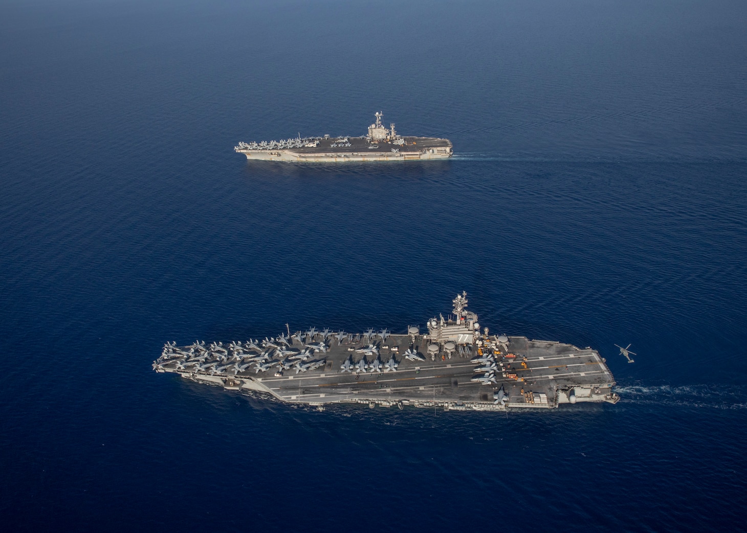 The Nimitz-class aircraft carrier USS George H.W. Bush (CVN 77), bottom, operates with the Nimitz-class aircraft carrier USS Harry S. Truman (CVN 75), Aug. 27, 2022.