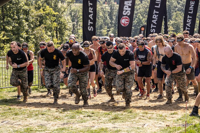 U.S. Marines, from Marine Corps Base Quantico, Va., start the run with the Marines event at the Sprint 5K at the 2022 West Virginia Spartan Trifecta Weekend Event in Glen Jean, West Virginia, Aug. 28, 2022.  Marine Corps Recruiting Command has partnered with the Spartan Race and their community of Athletes during 2022 through National and local level event activations. The partnership celebrates athletes' discipline, fighting spirit, and will to overcome obstacles and complete the mission are values shared with the Corps.