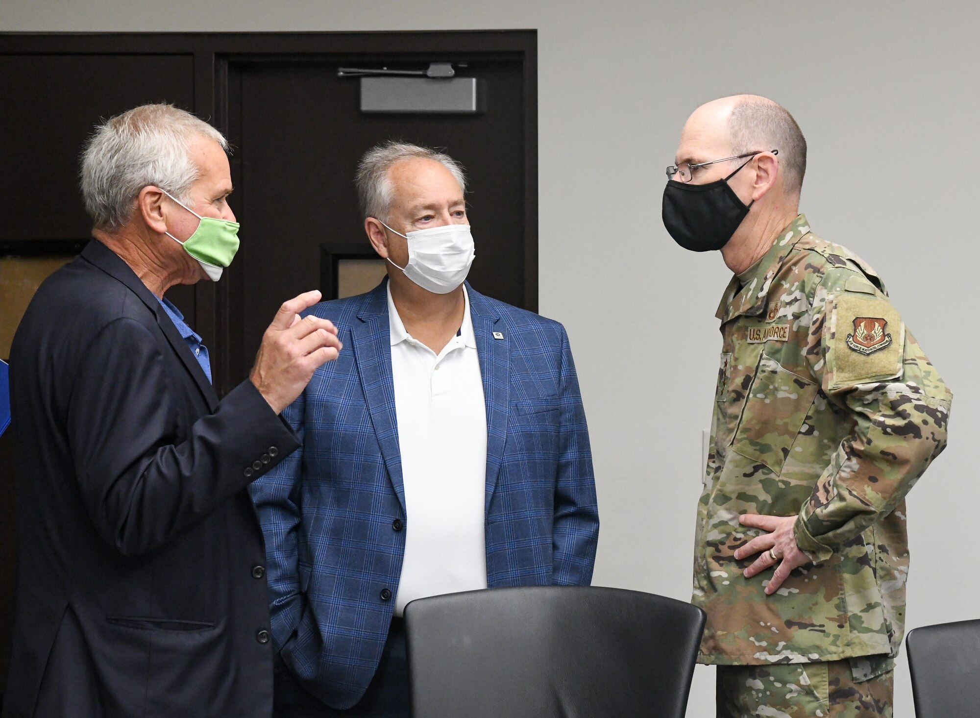 AFMC commander speaks with two civilians